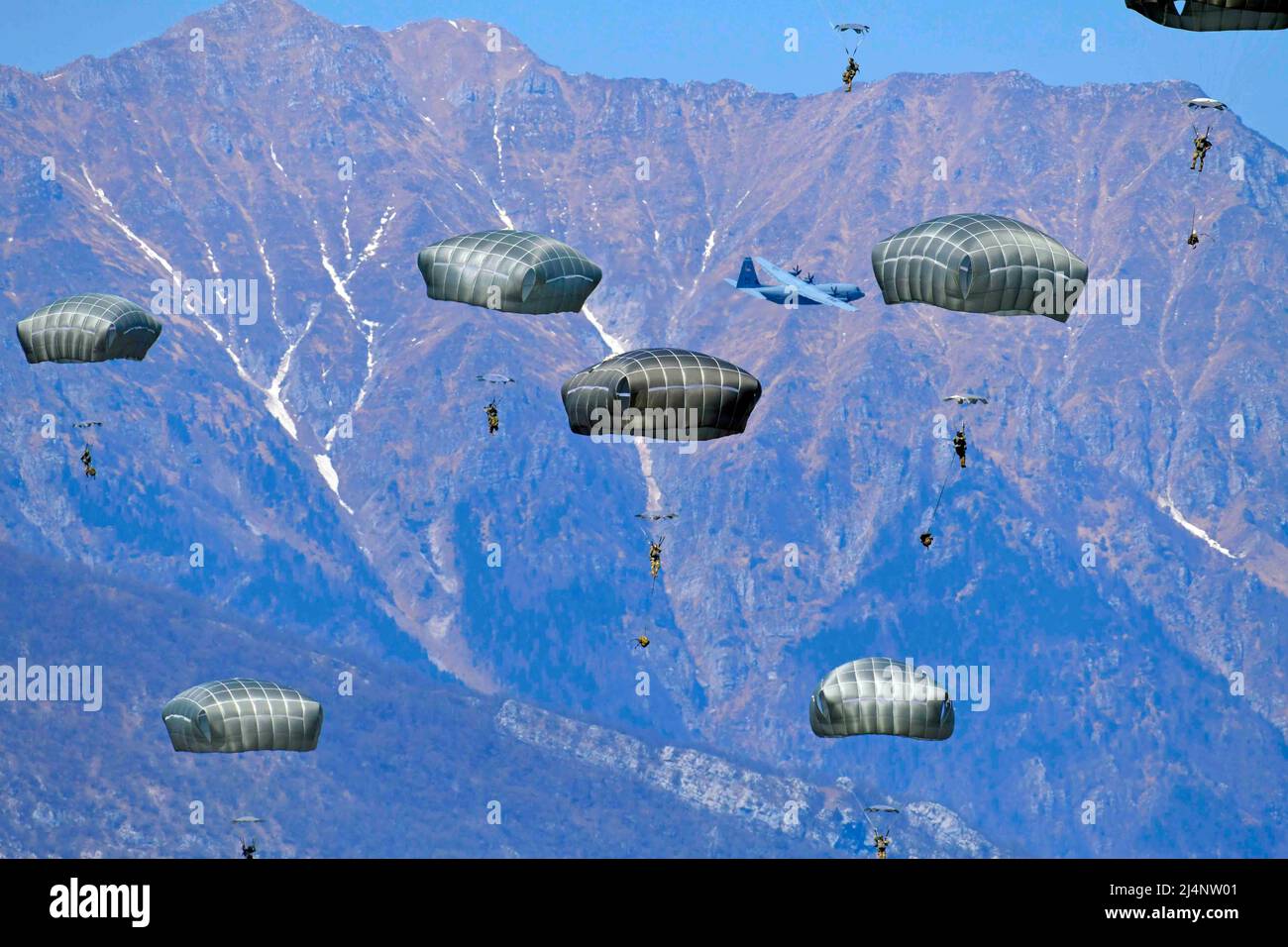 Pordenone, Italy. 12th Apr, 2022. U.S. Army paratroopers assigned to the 54th Brigade Engineer Battalion, 173rd Airborne Brigade, conduct an airborne operation from a U.S. Air Force 86th Air Wing C-130 Hercules aircraft onto Juliet Drop Zone in Pordenone, Italy on April 12, 2022. The 173rd Airborne Brigade is the U.S. Army Contingency Response Force in Europe, capable of projecting ready forces anywhere in the U.S. European, Africa or Central Commands' areas of responsibility. Credit: U.S. Army/ZUMA Press Wire Service/ZUMAPRESS.com/Alamy Live News Stock Photo