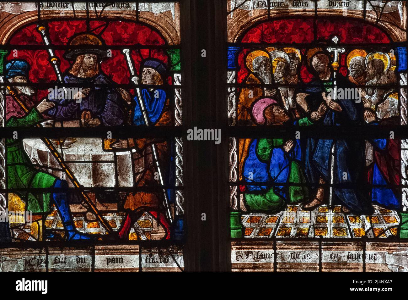 Two panels of vivid 16th century Renaissance stained glass, made by the master glass artists of the city of Troyes in France's Champagne region, depicting Jesus Christ appearing to the Apostles after he was crucified and rose from the dead.  The scene is part of the Resurrection window in the church of St Remy in the village of Ceffonds. Stock Photo