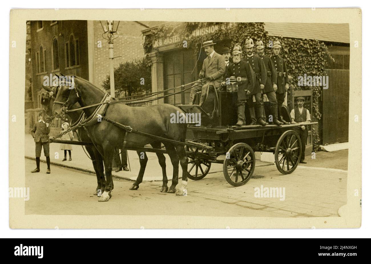 Wonderful original and clear Edwardian era early 1900's postcard of a proud fire crew wearing Merryweather brass helmets on a  horse-drawn fire engine, a community brigade (community is written on the helmets) possibly Uckfield, East Sussex, U.K. circa 1905 Stock Photo