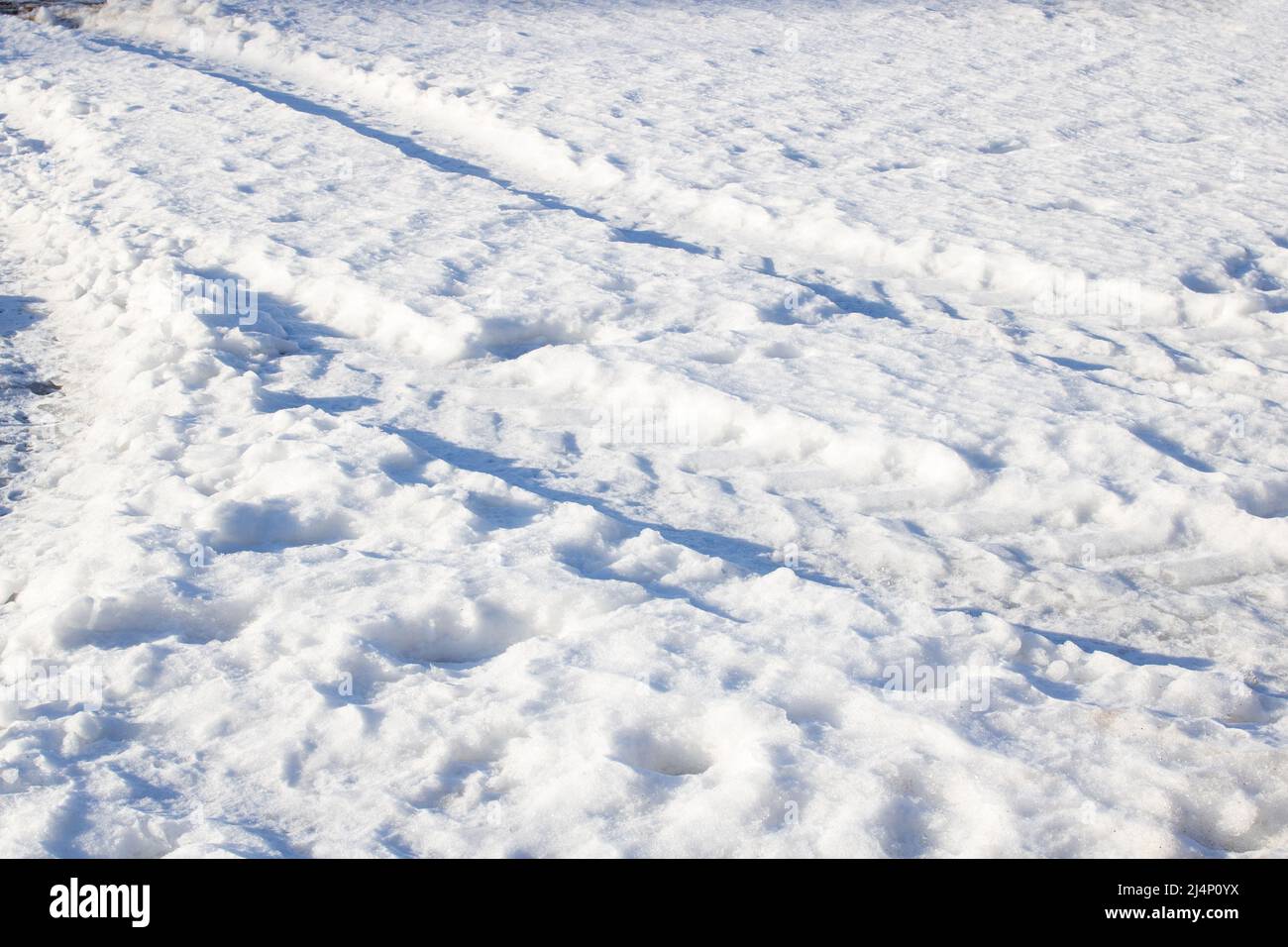 Car tracks in the snow in sunlight close up Stock Photo - Alamy