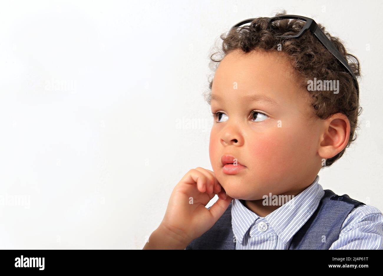 child looking to the side with background with people stock photo Stock