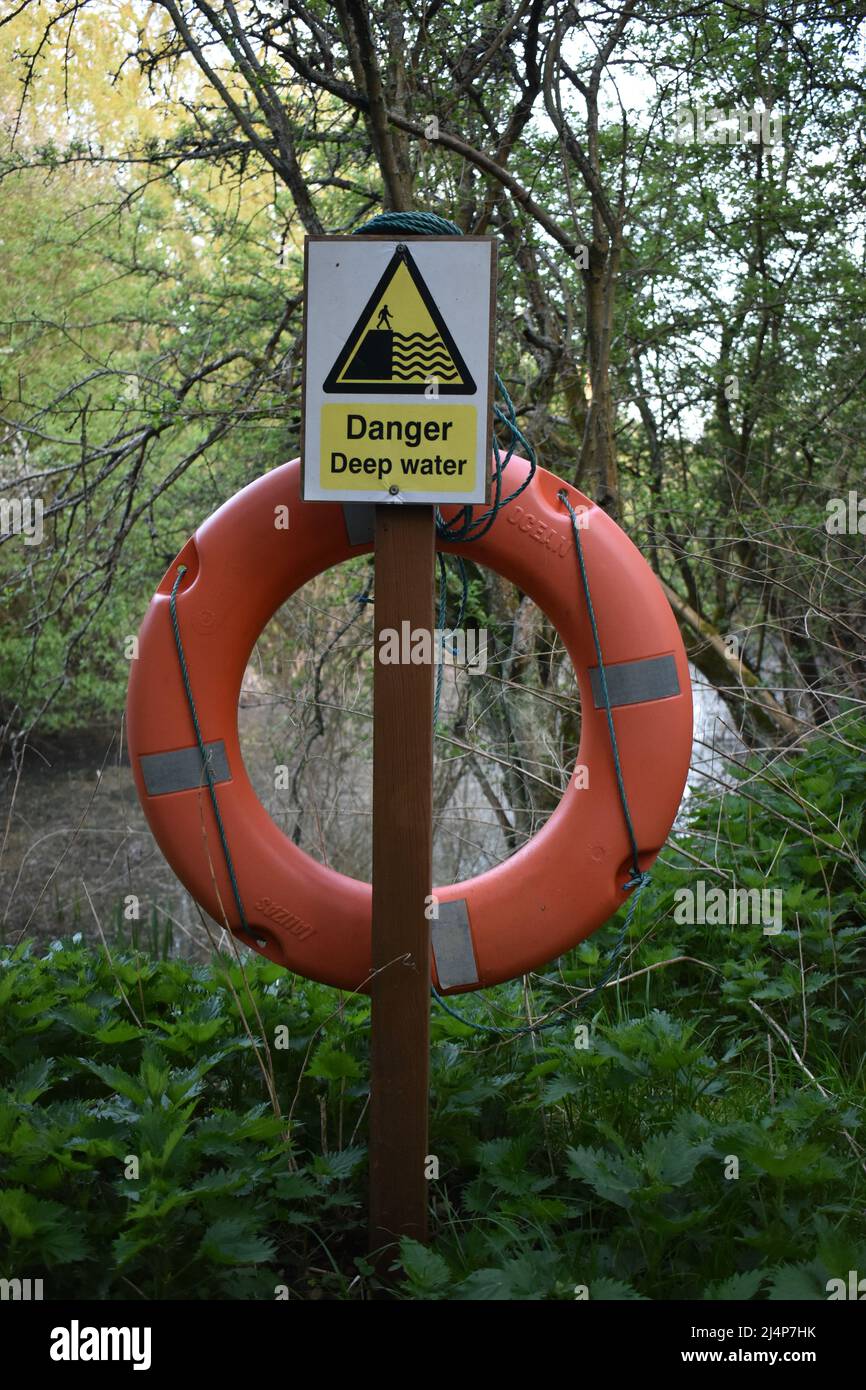 Sign: 'Danger Deep Water' with a life buoy. Stock Photo