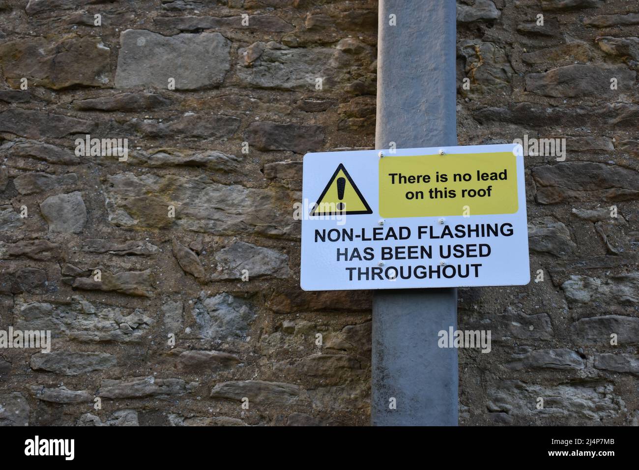 Notice with copyspace: 'There is no lead on this roof' 'Non-lead flashing has been used throughout'. Stock Photo