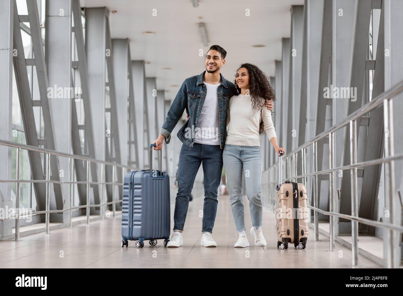 Portrait Of Smiling Arab Travellers Couple Standing With Suitcases At ...