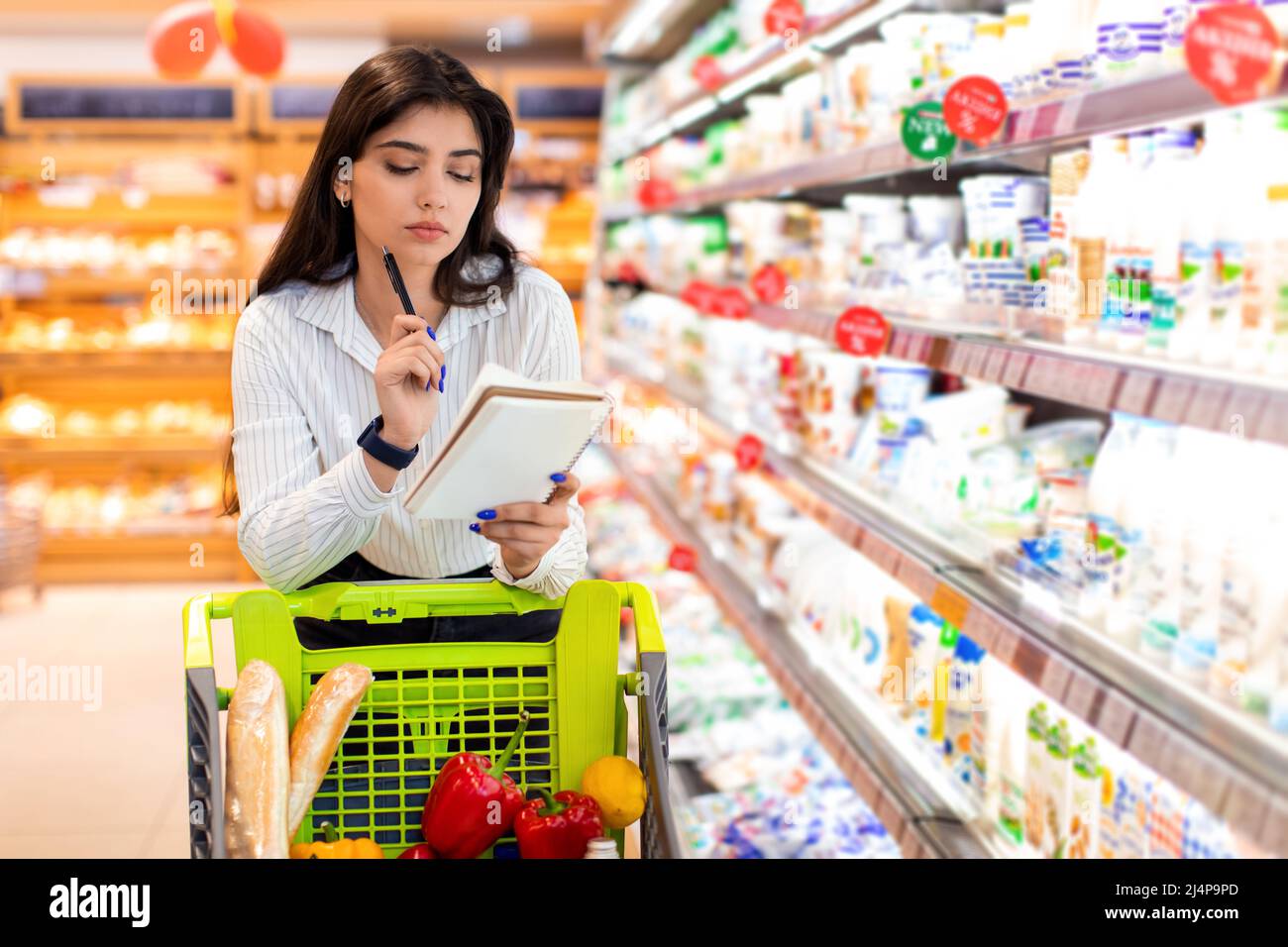 Middle Eastern Female Holding Shopping List Buying Products In
