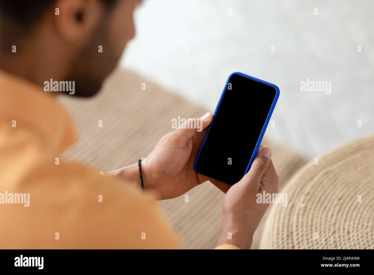 Young guy using cell with empty screen, mockup Stock Photo