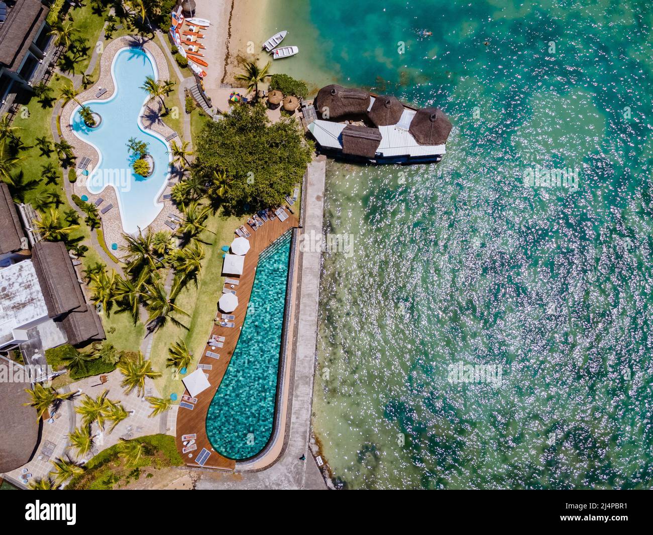 tropical pool with beach chairs and umbrellas, swimming pool in
