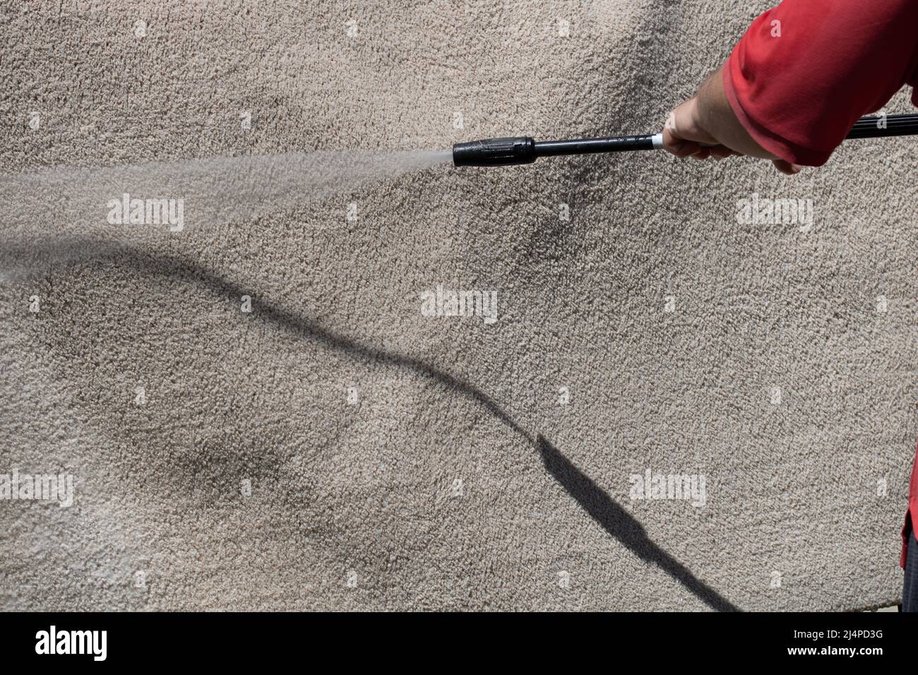 Washing carpets with high pressure washer. Cleaning the carpet with a