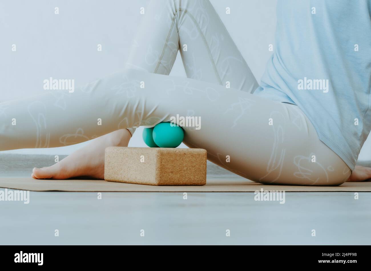 Hamstrings myofascial release massage with therapy balls on cork block