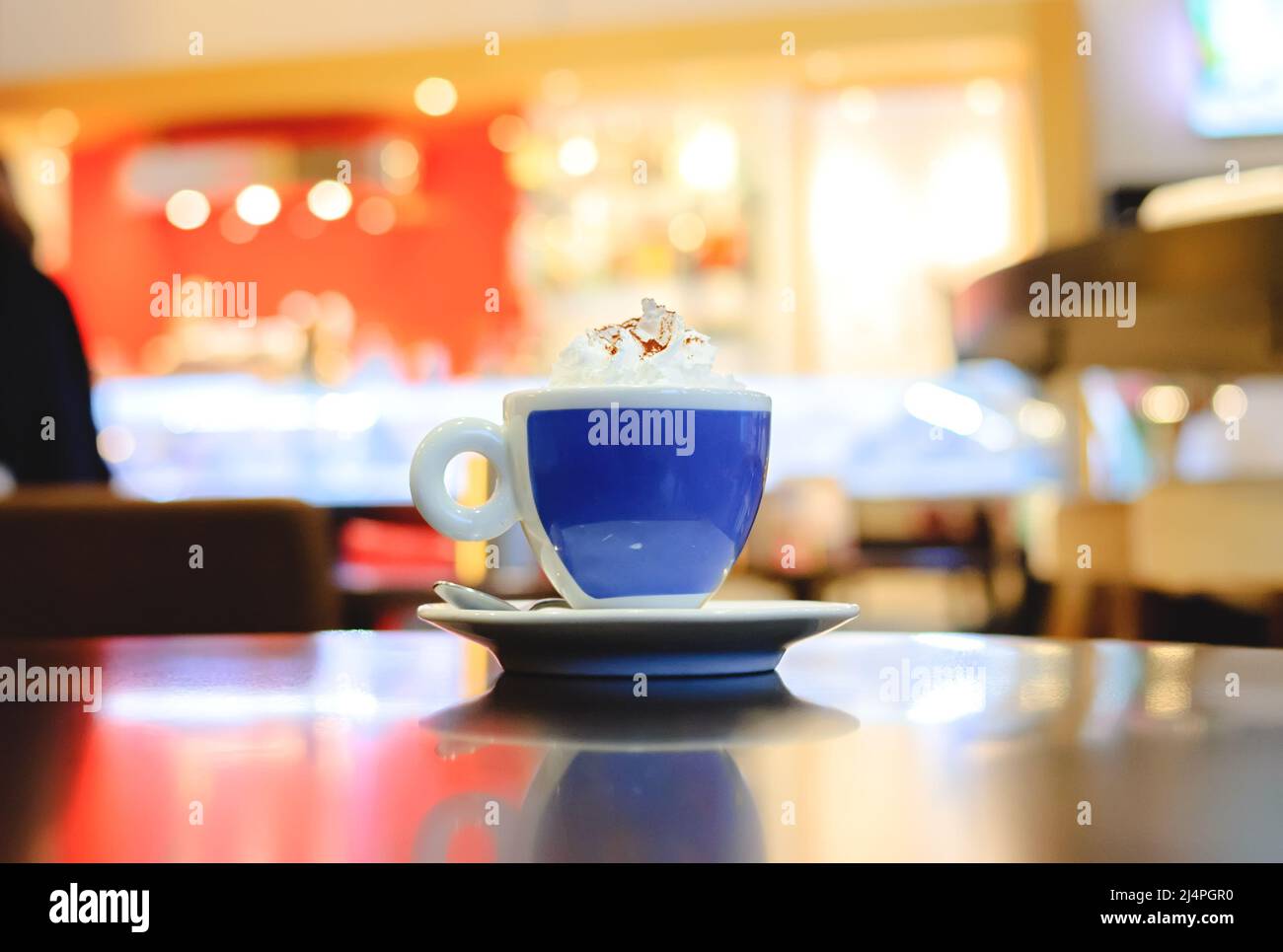 A cup of Viennese coffee with whipped cream on a table in a cafe Stock Photo