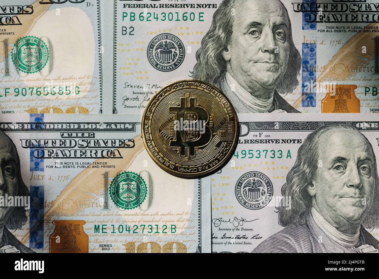 Golden shiny bitcoin crypto currency coins on one hundred US dollar bills.  Difference between cryptocurrencies and cash. Top view Stock Photo - Alamy