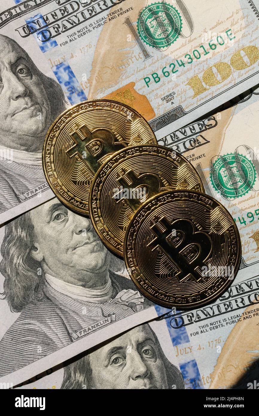 Bitcoin on banknotes of one hundred dollars. Exchange US dollars for