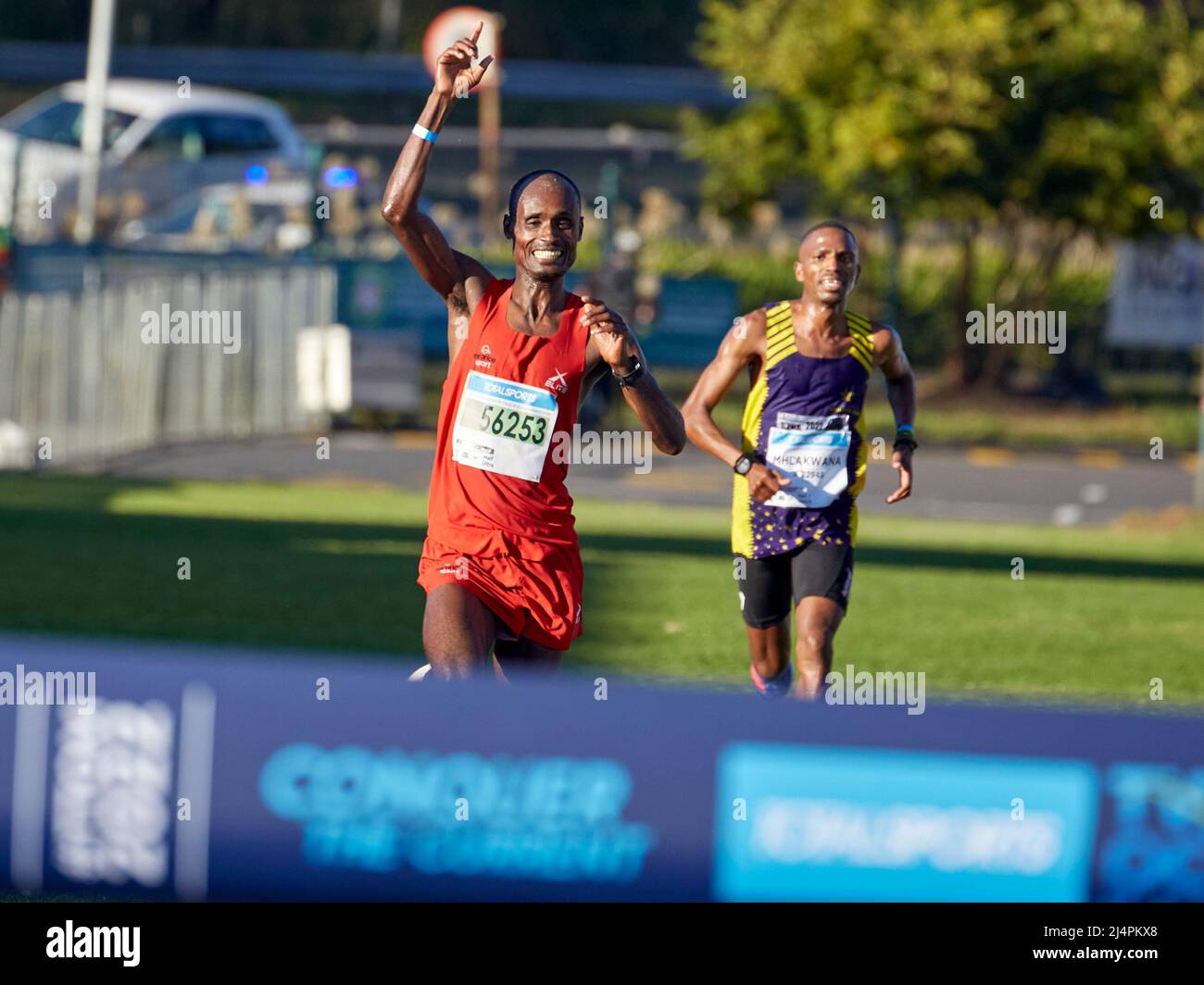 Cape Town, South Africa, 16th Apr 2022. Edndale Belachew, Mens Winner surges ahead of Nkosikhona Mhlakwana, in a sprint finish to the end. MO Bassa/Alamay Live News Stock Photo