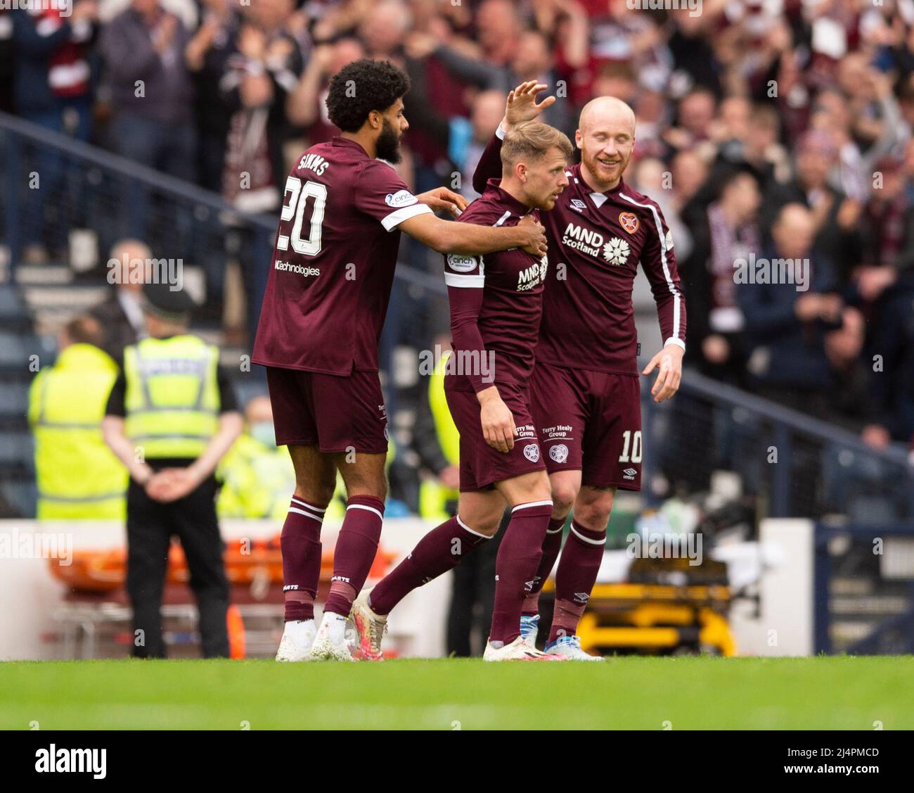 Glasgow, UK. 07th Apr, 2022. Scottish Cup semi final - Heart of Midlothian FC v Hibernian FC 07/04/2022 Pic shows: Hearts' left-back Stephen Kingsley is congratulated by teammates, Ellis Simms and Liam Boyce, after putting his side 2-0 in front in the 21st minute as Hearts take on Hibs in the Scottish Cup semi final at Hampden Park, Glasgow Credit: Ian Jacobs/Alamy Live News Stock Photo