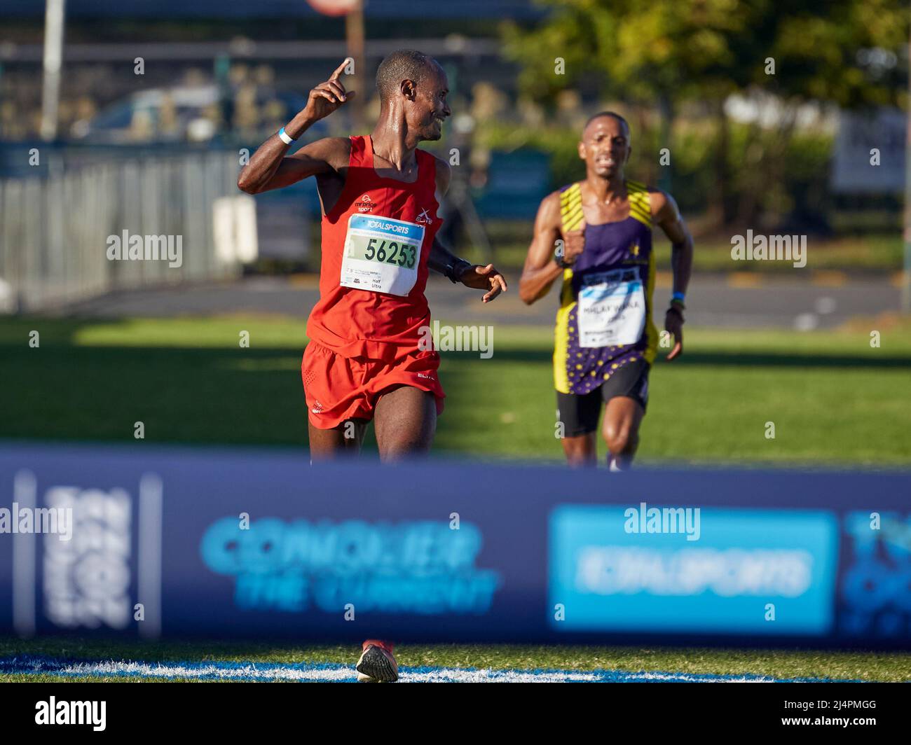 Cape Town, South Africa, 16th Apr 2022. Edndale Belachew, Mens Winner looks back at Nkosikhona Mhlakwana, in a sprint finish to the end. MO Bassa/Alamay Live News Stock Photo