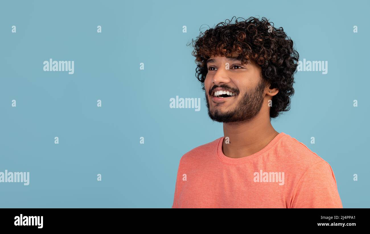 Cheerful hindu guy looking at copy space Stock Photo