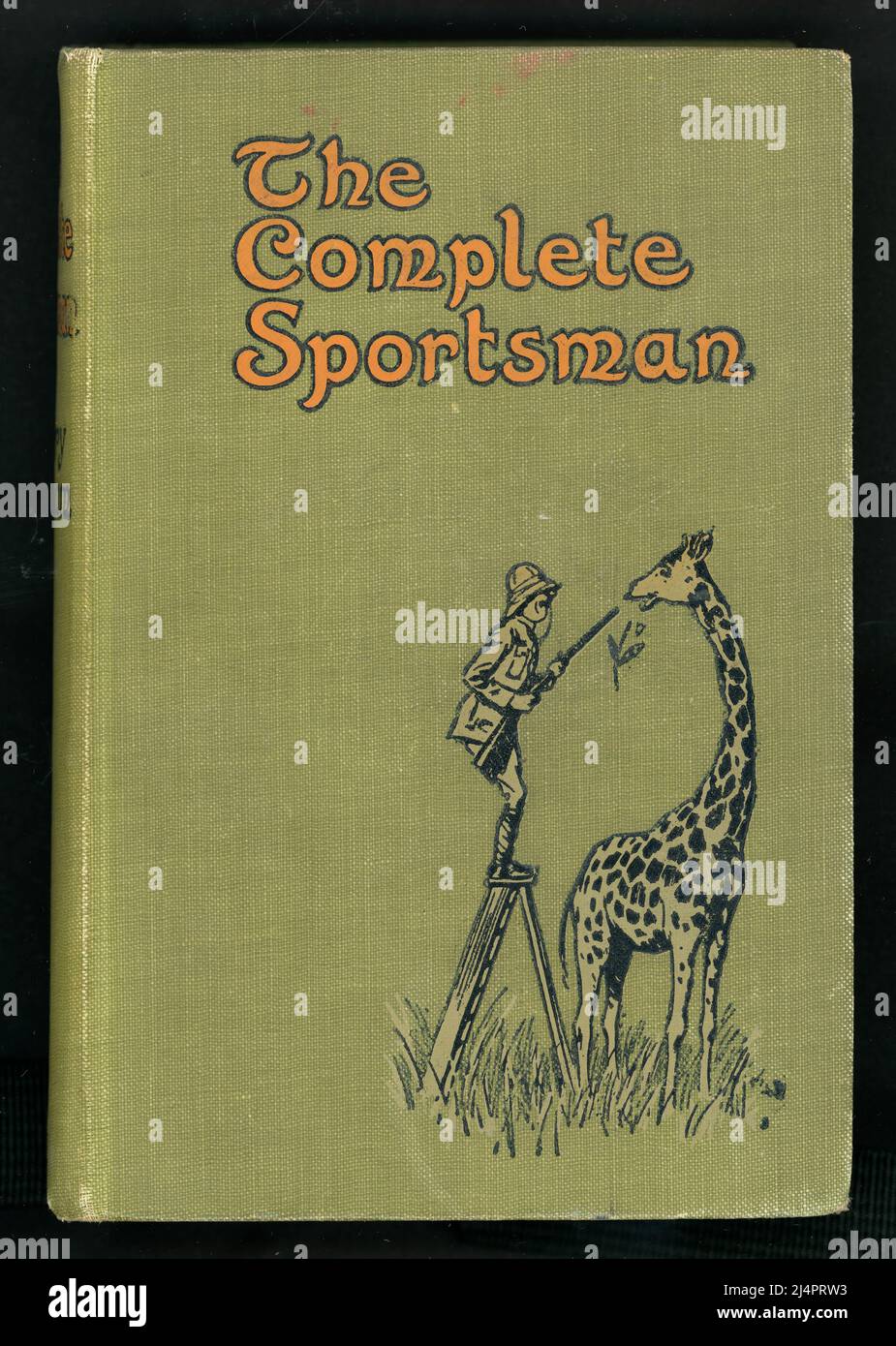 Original hardback first edition of The Complete Sportsman  (Compiled from the fictional sporting memoirs of Reginald Drake Biffin) with a cover of a big game hunter trying to shoot a giraffe.   Many of the articles published inside originally appeared in Punch, Pearson's Magazine, The Pall Mall Magazine, The Sphere, The Graphic and The Westminster Gazette. Published by Edward Arnold, London. 1914. Colonial edition., By Harry Graham. Illustrated by Lewis Baumer. 1914 Stock Photo