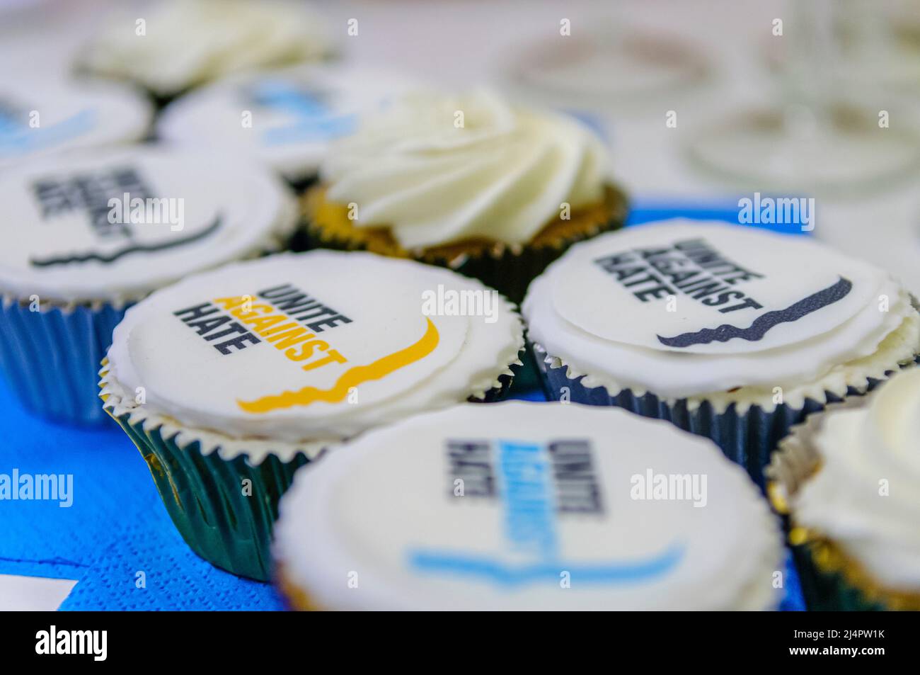 Cupcakes with the logo for 'Unite Against Hate', a Northern Ireland based organisation that educates people to tackle racism, homophobia, sectarianism and other hate crimes. Stock Photo