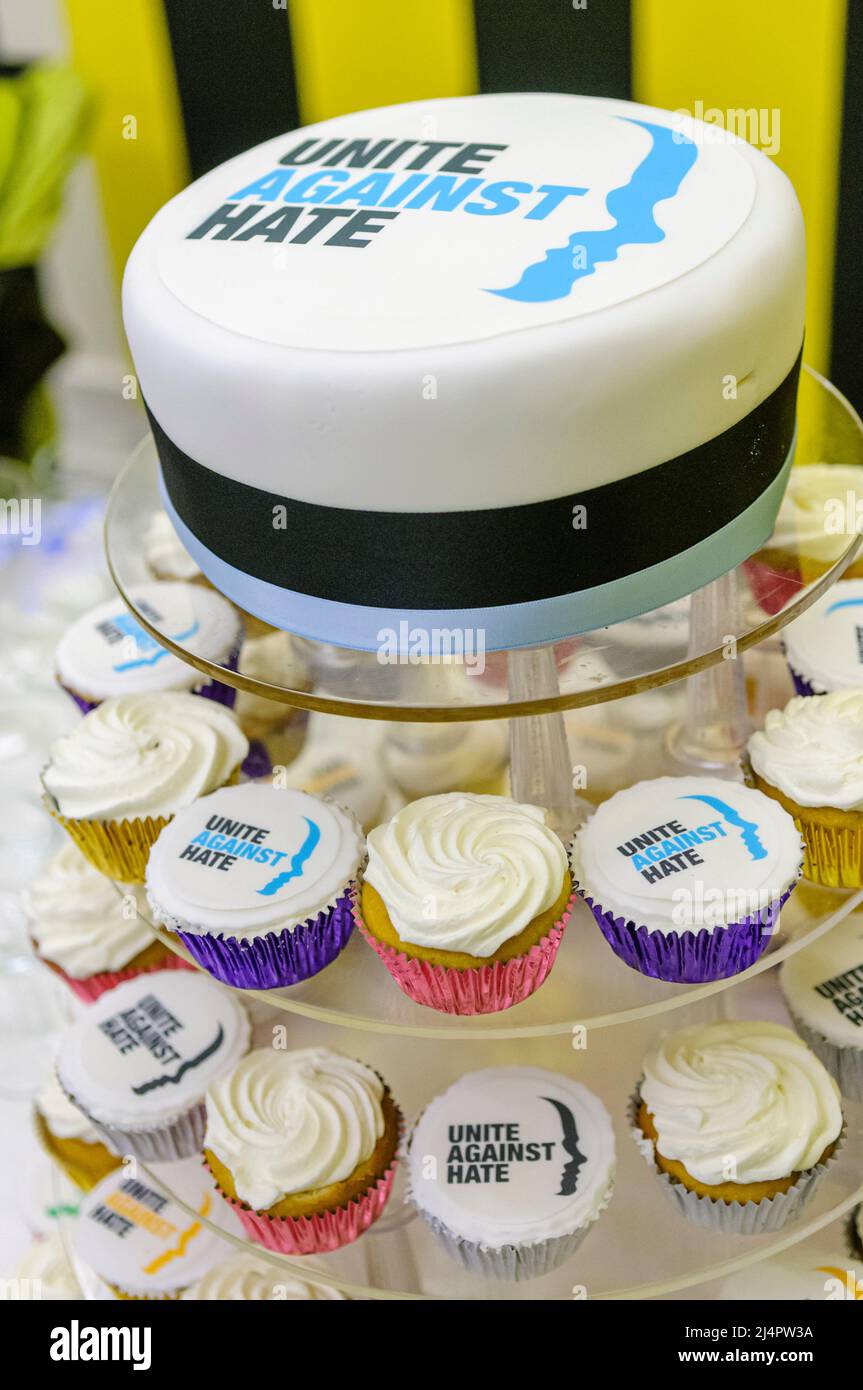 Cake and cupcakes with the logo for 'Unite Against Hate', a Northern Ireland based organisation that educates people to tackle racism, homophobia, sectarianism and other hate crimes. Stock Photo