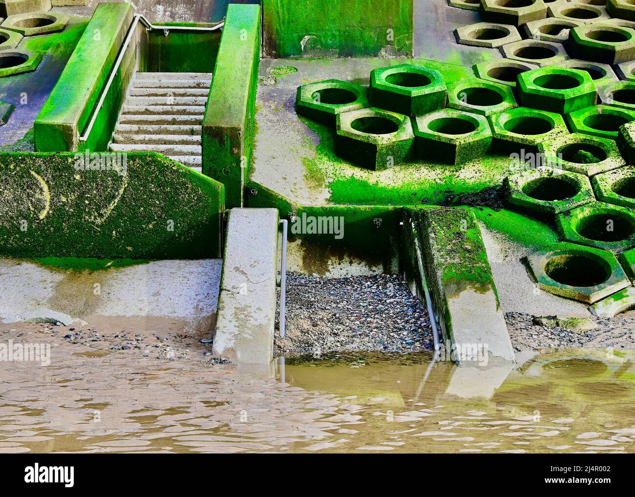 Example of tidel deposition and long shore drift on seawall steps in Blackpool Stock Photo