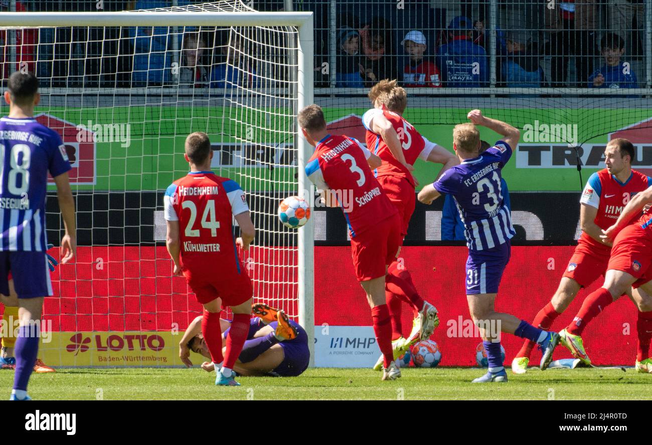 Heidenheim, Germany. 17th Apr, 2022. Soccer: 2. Bundesliga, 1. FC Heidenheim - Erzgebirge Aue, Matchday 30, Voith-Arena. Aue's Ben Zolinski (2.vr) scores the 0:1. Credit: Stefan Puchner/dpa - IMPORTANT NOTE: In accordance with the requirements of the DFL Deutsche Fußball Liga and the DFB Deutscher Fußball-Bund, it is prohibited to use or have used photographs taken in the stadium and/or of the match in the form of sequence pictures and/or video-like photo series./dpa/Alamy Live News Stock Photo