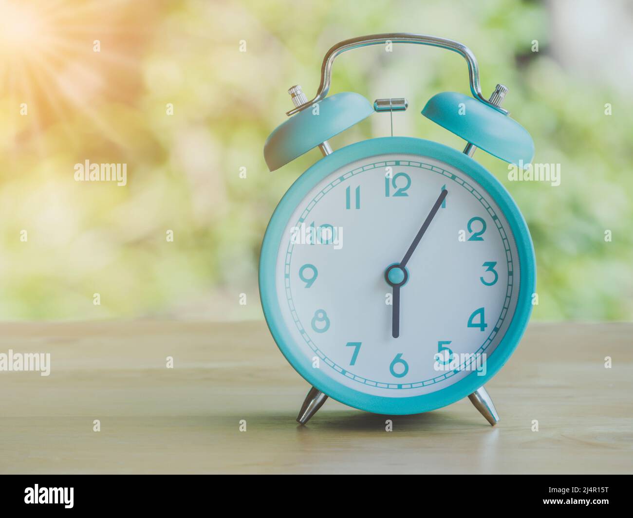 Retro alarm clock 6 o'clock AM or PM with morning sun with flare light