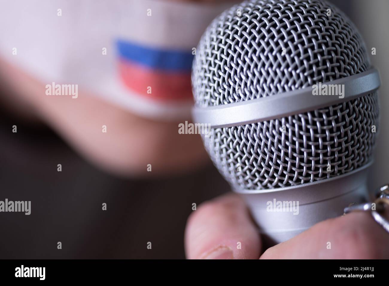 A duct-taped mouth with a Russian flag, trying to speak into a microphone.  The concept of freedom of the press in Russia Stock Photo - Alamy