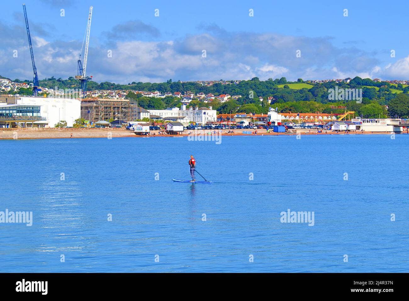 View of Paignton town seaside and beach with a long pier juts out from