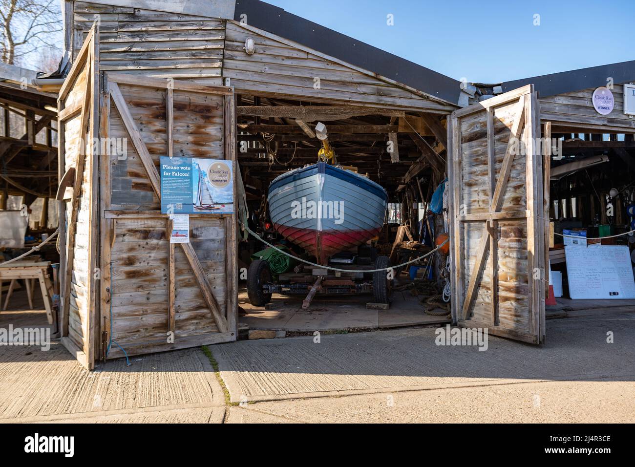 Woodbridge, Suffolk, UK March 18 2022: Traditional wooden sailboat in a workshop undergoing work and restoration Stock Photo