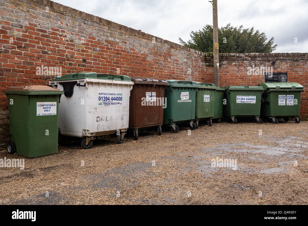 Woodbridge Suffolk UK April 05 2022: A row of wheelie bins waiting for collection, they are for general waste, mixed recycling, trade waste and compos Stock Photo