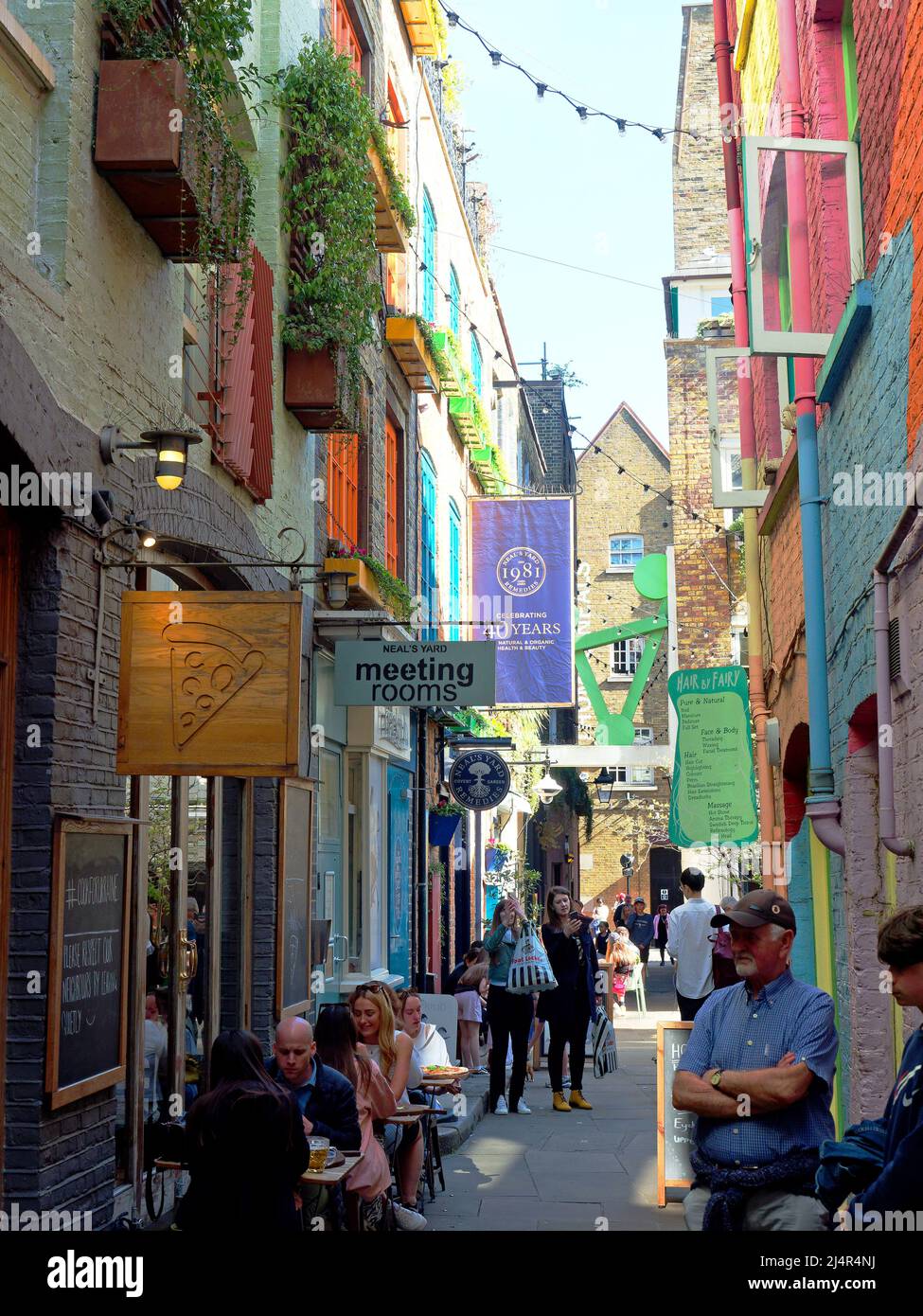 View of Neal's Yard a colourful hidden courtyard of independent restaurants, bars and shops near Seven Dials in Covent Garden London Stock Photo