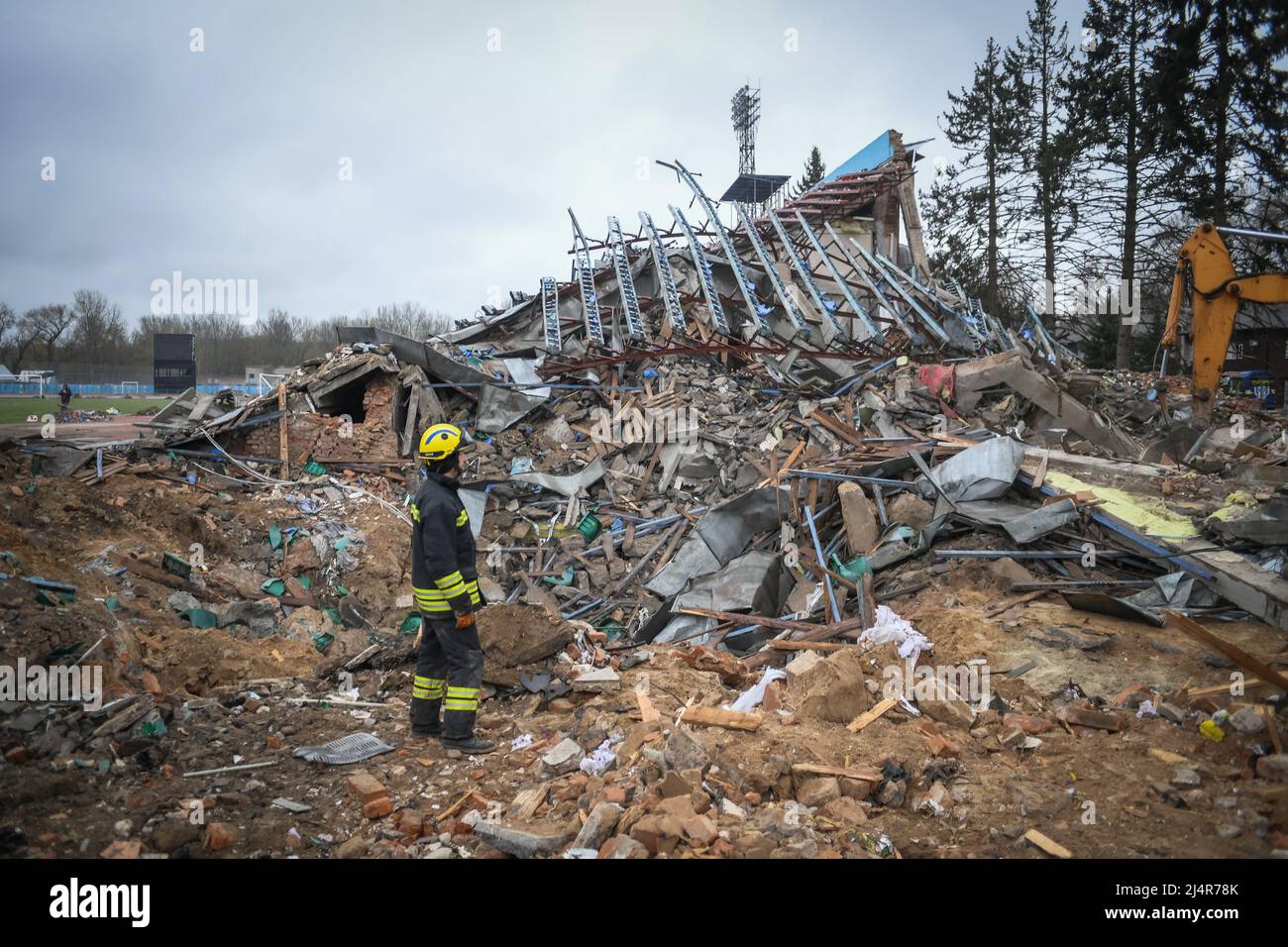 Ukraine. 16th Apr, 2022. A fire fighter works on rubbles in a football pitch at the stadium a residential area of Chernihiv, Ukraine damaged by shelling during the Russian invasion on April 16, 2022. Russian military forces entered Ukraine territory on Feb. 24, 2022. (Photo by Piero Cruciatti/Sipa USA) Credit: Sipa USA/Alamy Live News Stock Photo