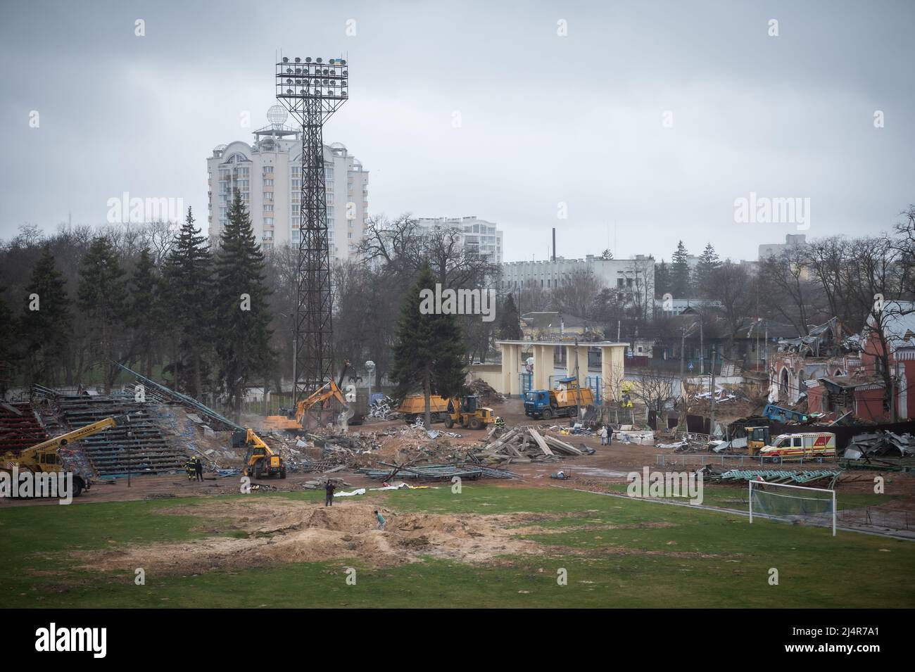 Ukraine. 16th Apr, 2022. People inspect a crater in a football pitch at the stadium a residential area of Chernihiv, Ukraine damaged by shelling during the Russian invasion on April 16, 2022. Russian military forces entered Ukraine territory on Feb. 24, 2022. (Photo by Piero Cruciatti/Sipa USA) Credit: Sipa USA/Alamy Live News Stock Photo