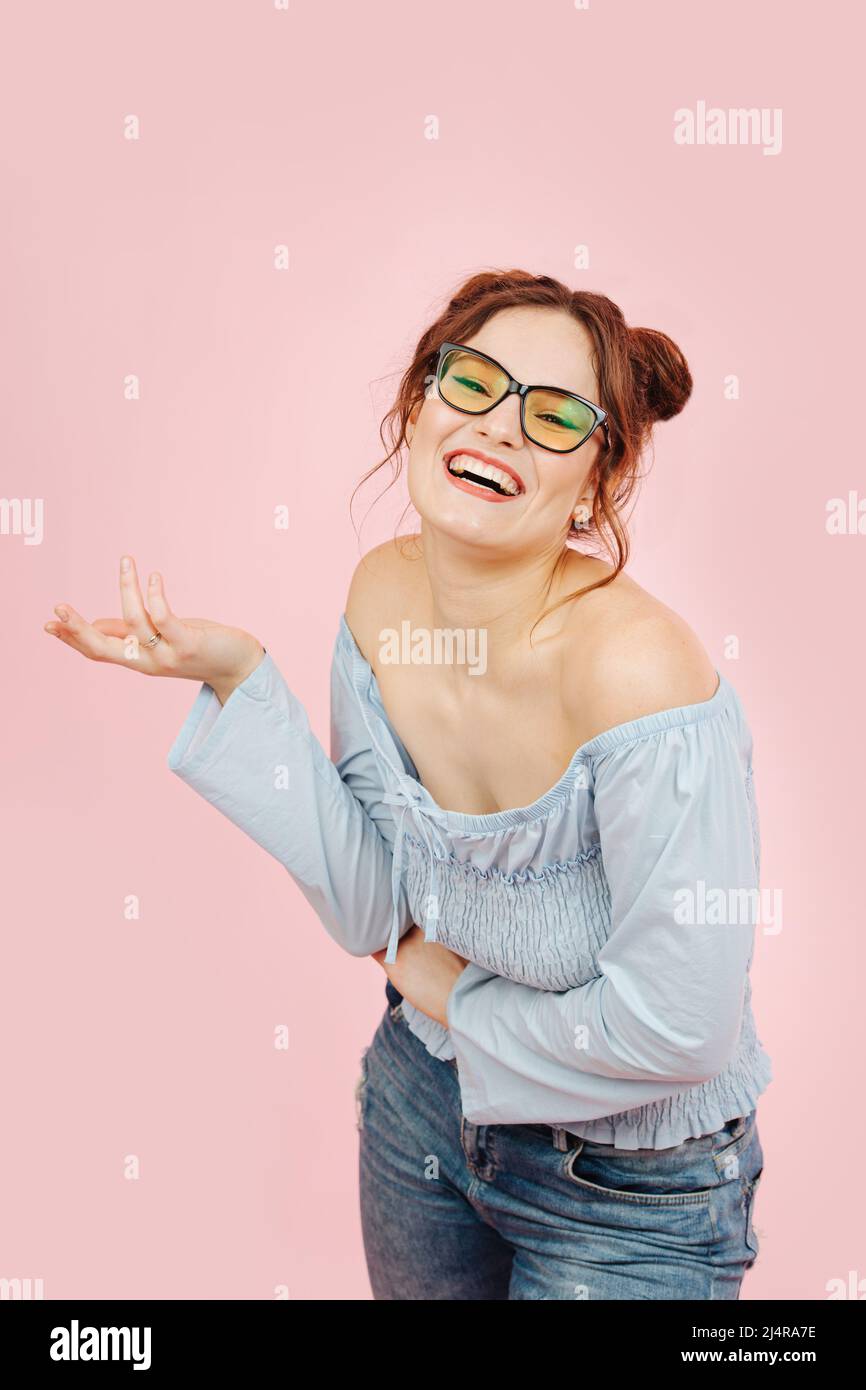Chatty eccentric lady laughing, talking and gesturing. Over pink background. Stock Photo