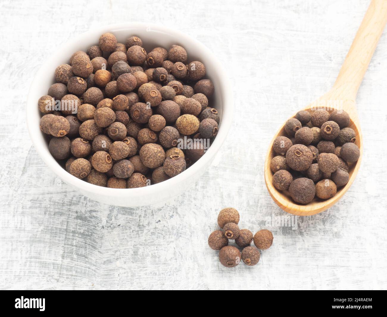 Spice Allspice (Jamaica pepper, Pimento) in white ceramic bowl wooden ...