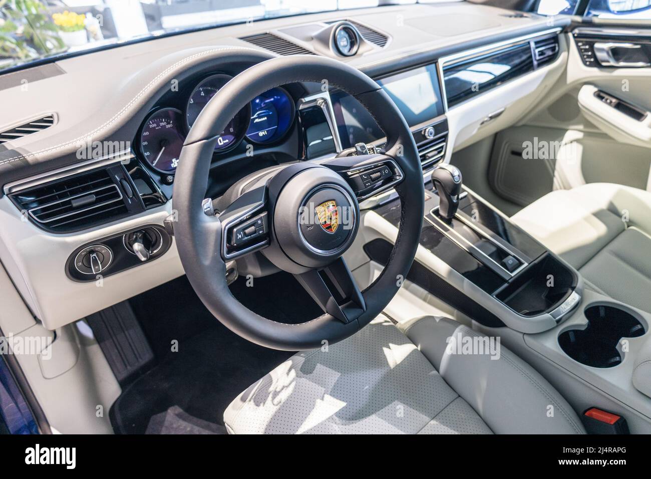 Porsche Macan interior - steering wheel with logo and buttons, dashboard and speedometer Stock Photo