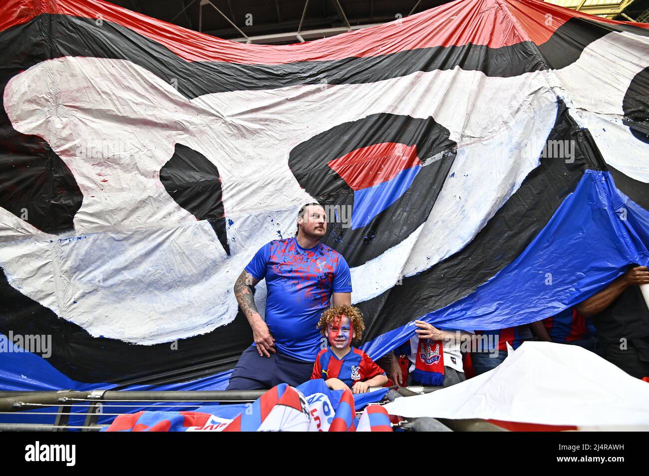 As a big Crystal Palace banner is unfurled a man and his son apper underneath during the FA Cup Semi Final match between Chelsea and Crystal Palace at Wembley Stadium on April 17th 2022 in London, England. (Photo by Garry Bowden/phcimages.com) Stock Photo