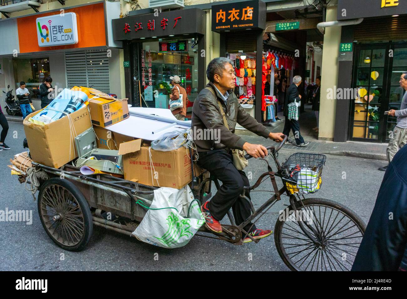 Shanghai, China, Street Scene, Chinese Man, riding bike city Trash Recycling Collection on Bicycle, in CIty Center Stock Photo