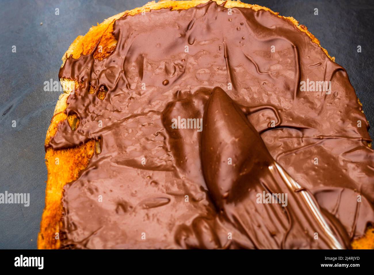 Spreading chocolate cream on toasted bread Stock Photo
