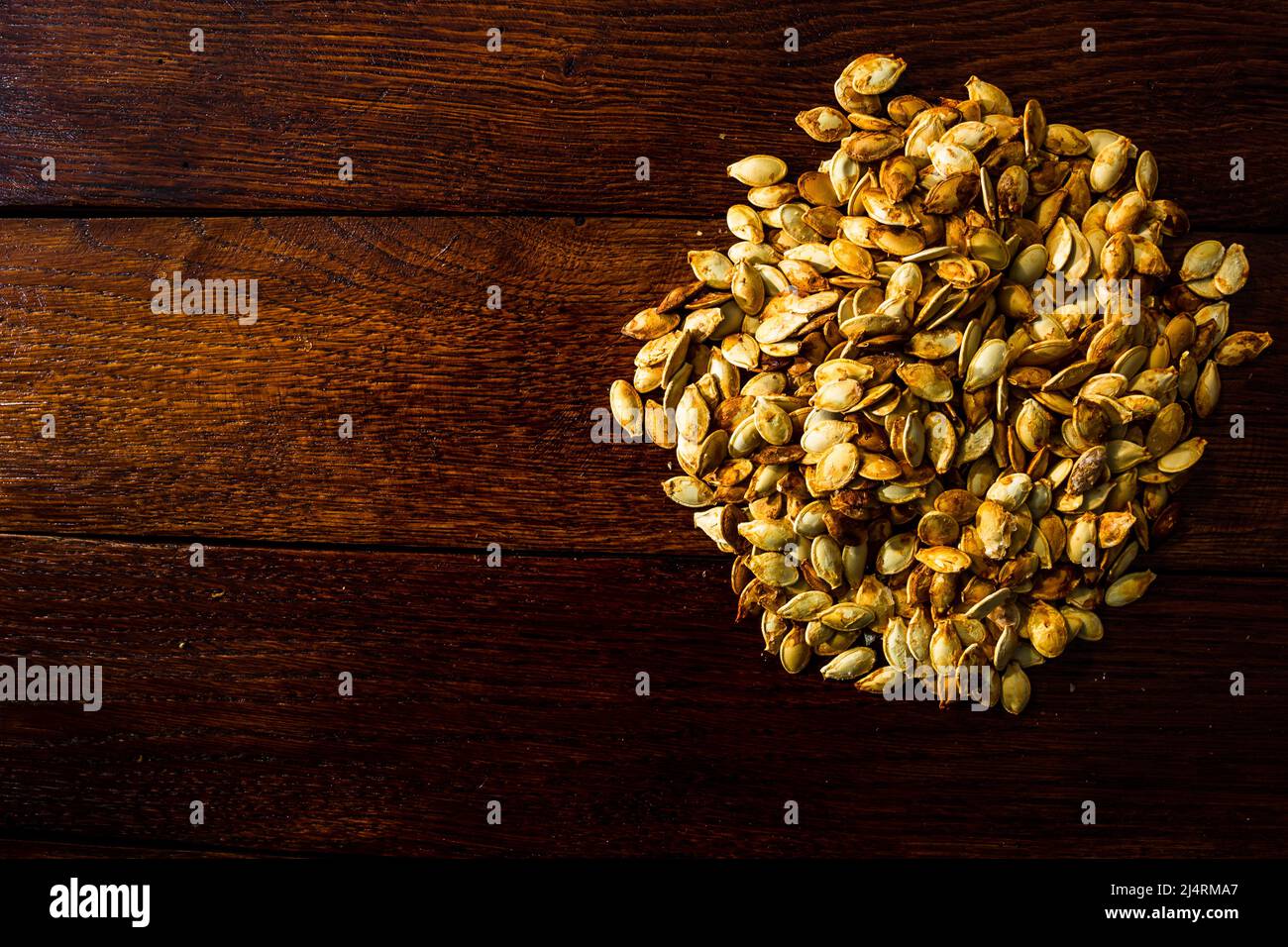 Roasted salty pumpkin seeds hi-res stock photography and images - Alamy