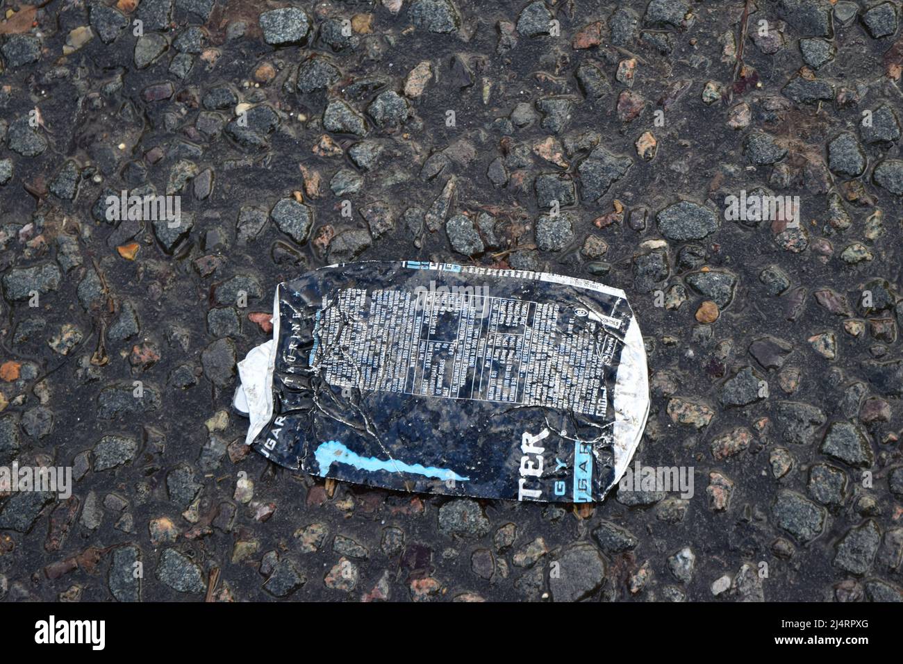 flattened monster drinks can on the ground, england Stock Photo