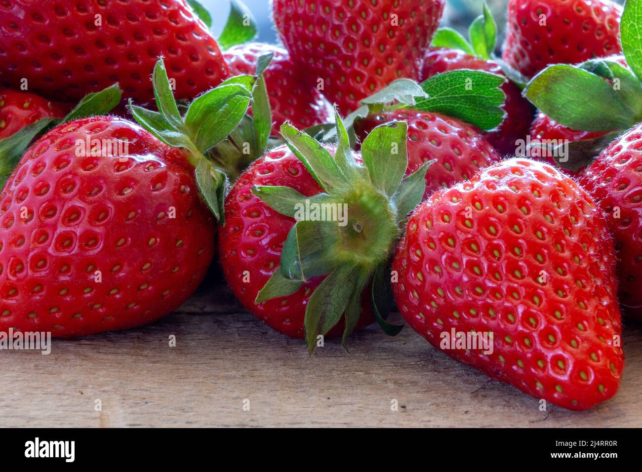 Fresh strawberries over old wooden table Stock Photo