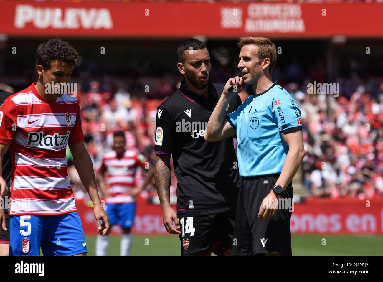 Granada, Spain. 17th Apr, 2022. The referee Pizarro Gomez listen to the instructions of the Var during the Liga match between Granada CF and UD Levante at Nuevo Los Carmenes Stadium on April 17, 2022 in Granada, Spain. (Photo by José M Baldomero/Pacific Press) Credit: Pacific Press Media Production Corp./Alamy Live News Stock Photo