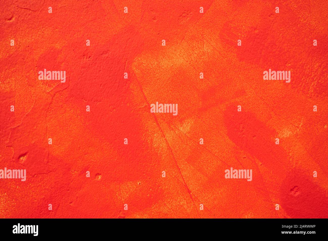 detail of an irregular stucco wall painted red or orange Stock Photo