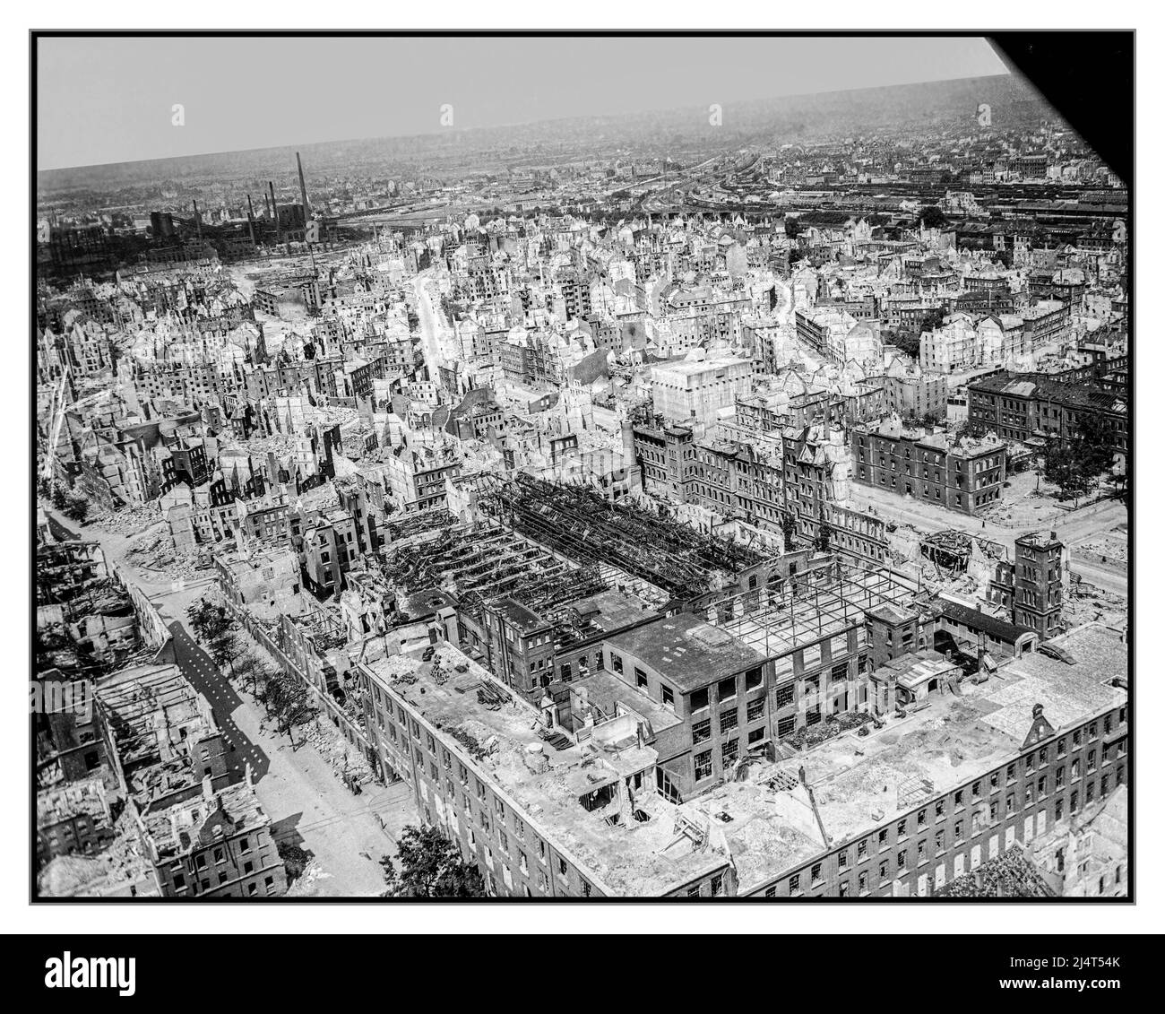 NUREMBERG WW2 Allied Bombing damage devastation arial view at Nuremberg Nazi Germany May 1945 Oblique aerial view of heavily-damaged industrial and residential buildings in Nuremberg. Visible at the centre of the photo is a multi-story above-ground air raid bunker. At the bottom of the photo, below the bunker, is the Siemens plant. Top left is the gas works in Nürnberg-Sandreuth, top right is the main station (Hauptbahnhof) Date Taken on 28 May 1945 ( 3 weeks after the unconditional surrender by Nazi Germany) Stock Photo