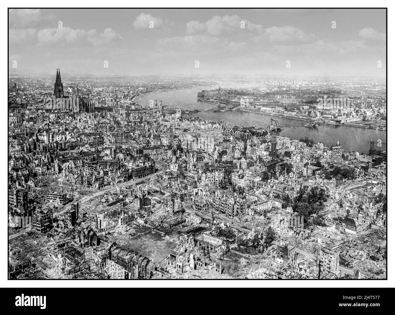 WW2 Allied Bomb damage Cologne Nazi Germany The Kölner Dom (Cologne Cathedral) stands seemingly undamaged (although having been directly hit several times and damaged severely) while entire area surrounding it is completely devastated. The Hauptbahnhof (Köln Central Station) and Hohenzollern Bridge over The River Rhine lie damaged to the north and east of the cathedral. The 30/31 May 1942 attack on Cologne was the first 1,000 bomber raid. Occupied Germany, 24 April 1945. Stock Photo