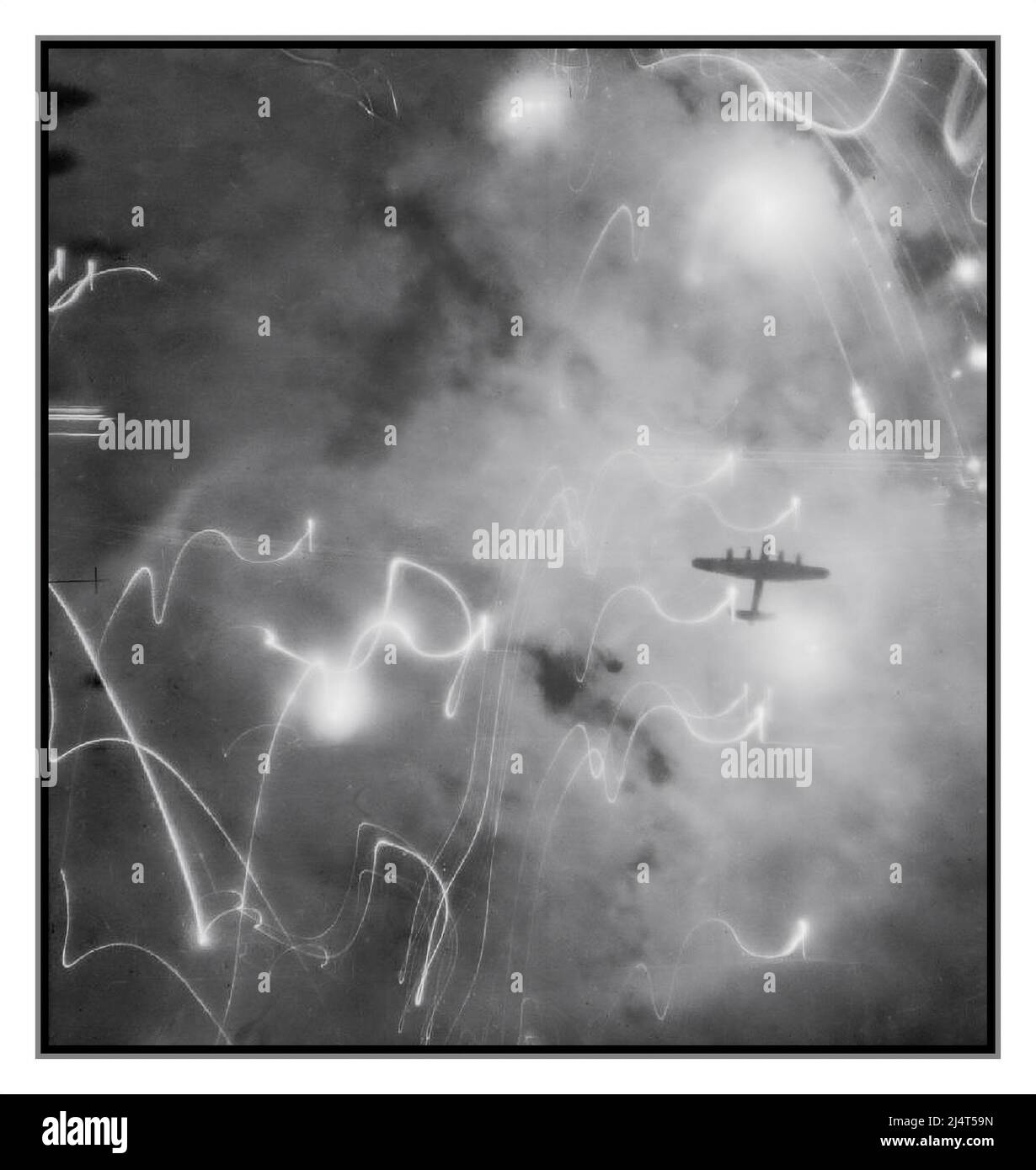 BOMBING RUN NIGHT WW2 HAMBURG Remarkable reconnaissance image illustrating the chaos of flares and enemy fire with Allied bombing runs over Nazi Germany An Avro Lancaster of No. 1 Group Bomber Command, silhouetted against flares, smoke and explosions during the attack on Hamburg, Germany, by aircraft of Nos. 1, 5 and 8 Groups on the night of 30/31 January 1943. This raid was the first occasion on which H2S centimetric radar was used by the Pathfinder aircraft to navigate the bombing run. Lest we forget the bravery and huge sacrifice of RAF British Bomber Command Crews.... Stock Photo