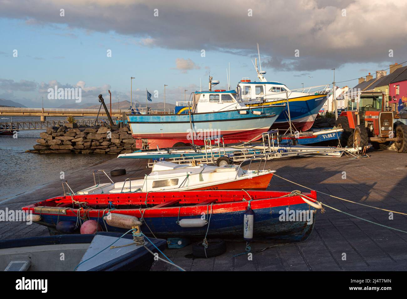 Easter Sunday 17th April 2022. Portmagee, County Kerry, Ireland. Warm evening sunlight lighting up the harbour at Portmagee, County Kerry, Ireland. Stock Photo