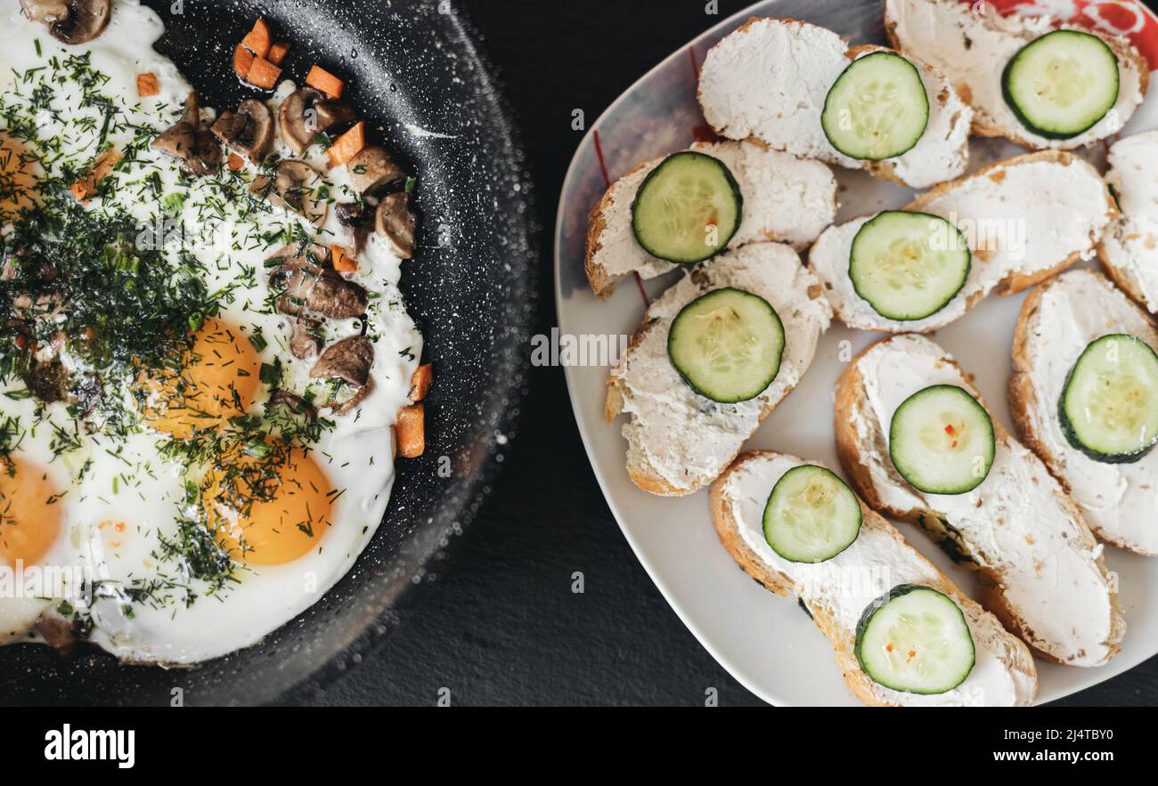 fried eggs in a frying pan and toast with cheese cream. unhealthy food Stock Photo Alamy