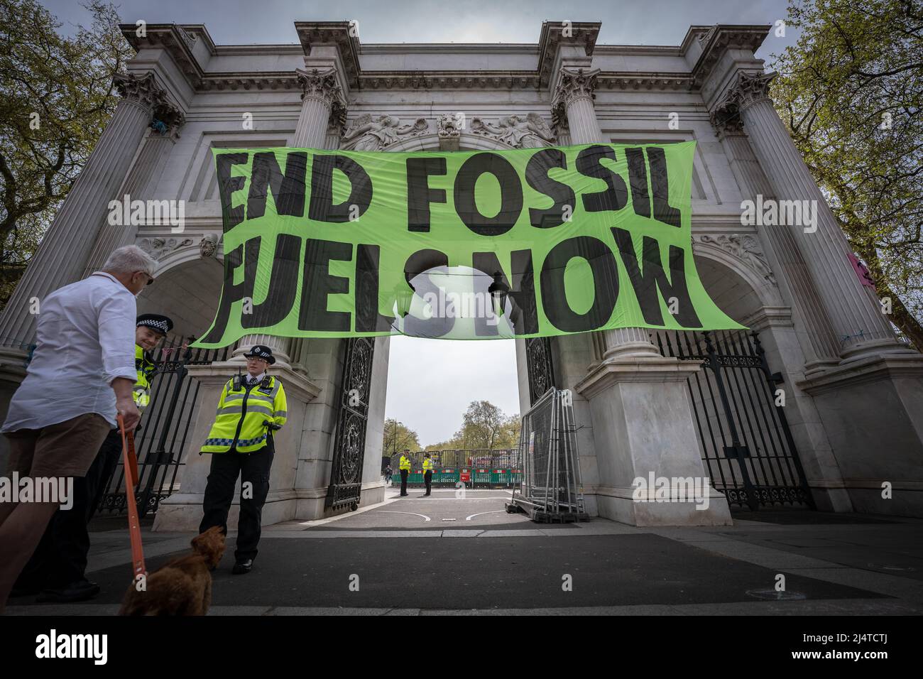 London, UK. 17th April, 2022. Extinction Rebellion protesters banner drop “END FOSSIL FUELS NOW” over the entrance to Marble Arch. Credit: Guy Corbishley/Alamy Live News Stock Photo